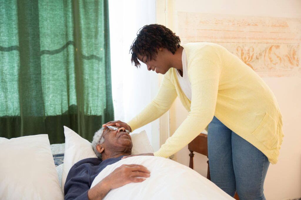 Woman Touching Elderly Mans Head